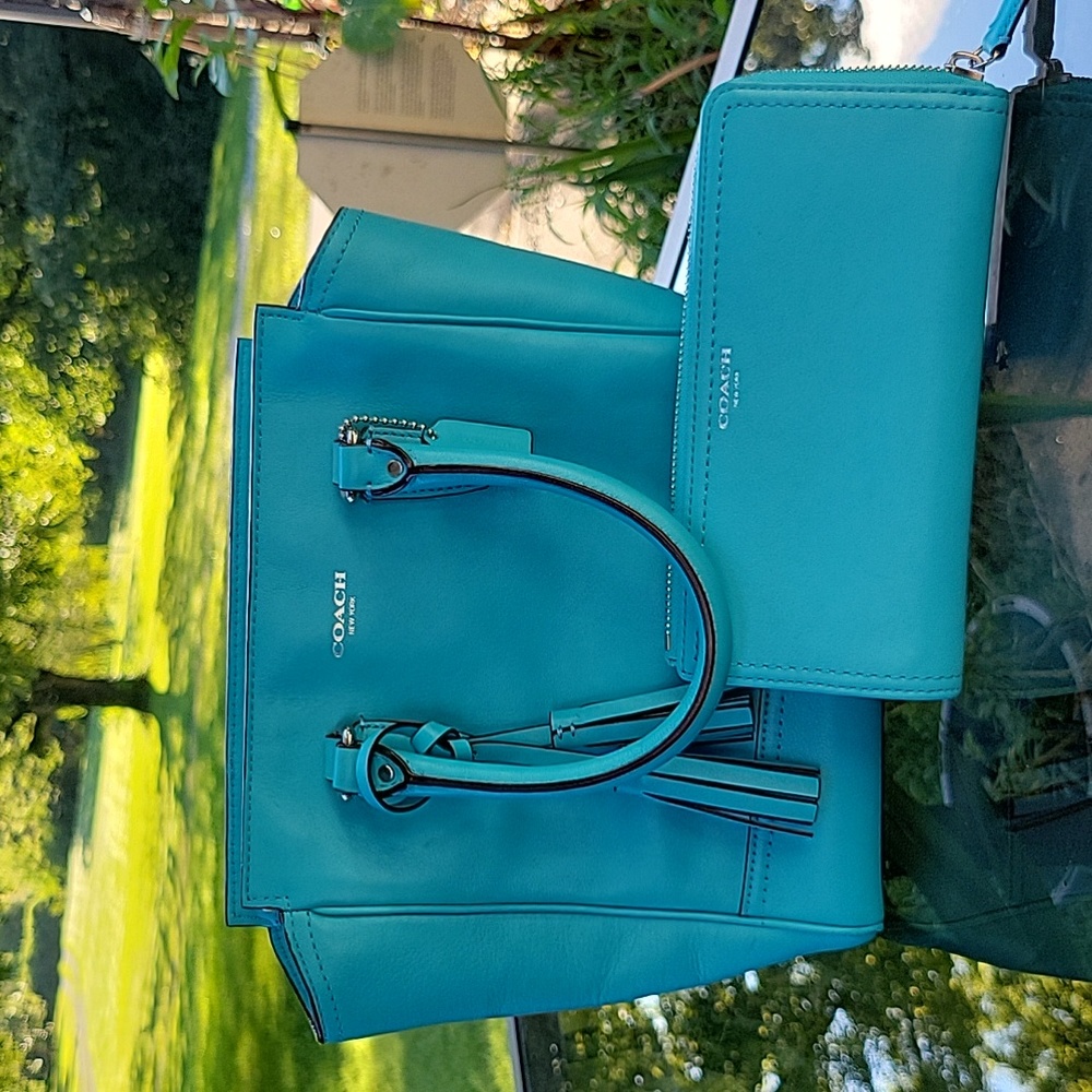 Blue coach bag with matching wallet.